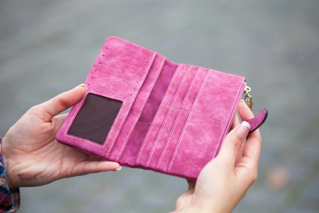 Hands holding an empty wallet, a sign you need a paycheck to paycheck budget