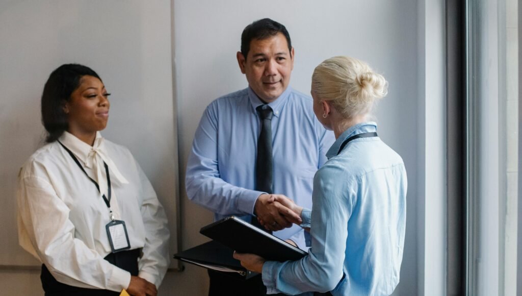 Professionals shaking hands while discussing self-employed health insurance