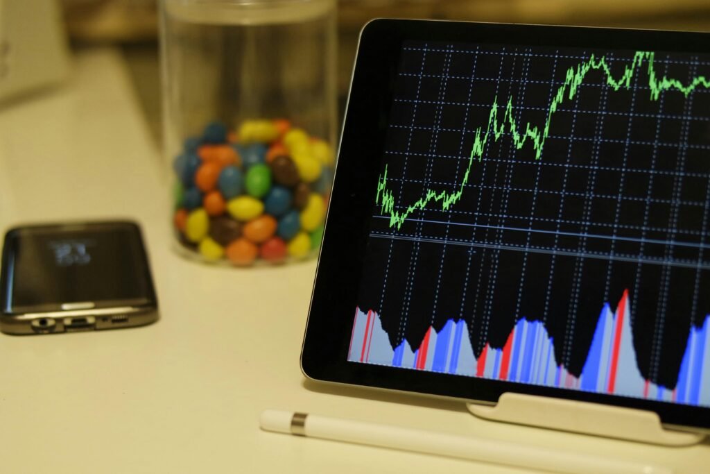 Phone showing a stock chart for investing with $100