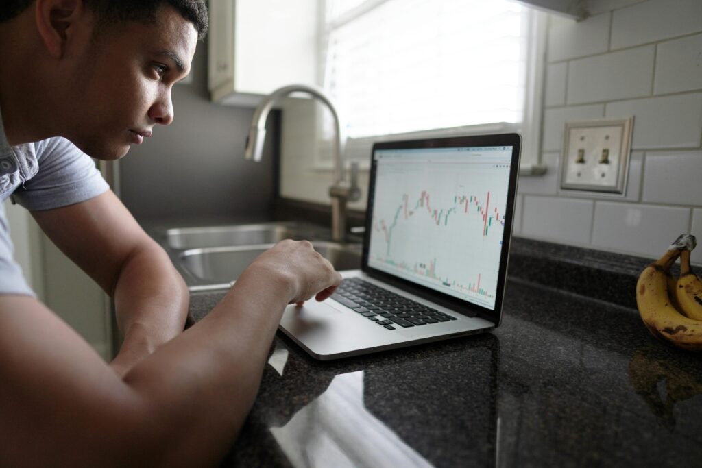 Man checking a laptop chart as he decides to open a Roth IRA