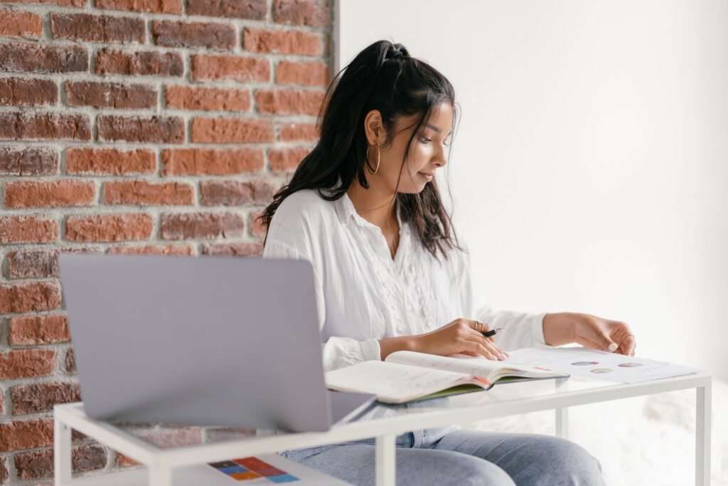 How to set financial goals — person writing down short and long-term financial goals in a notebook