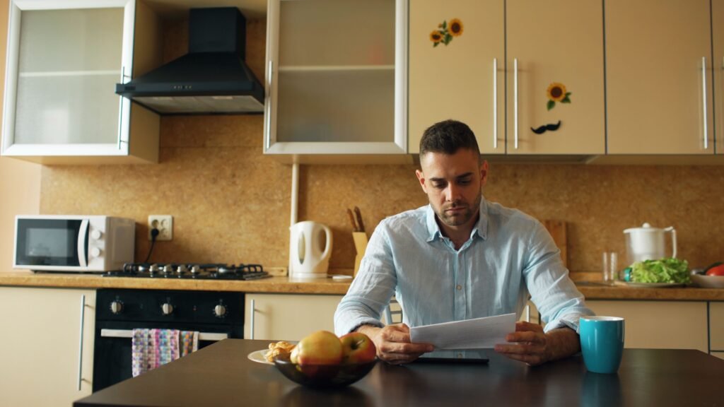 What is a home equity loan — homeowner calculating equity and fixed monthly payments.