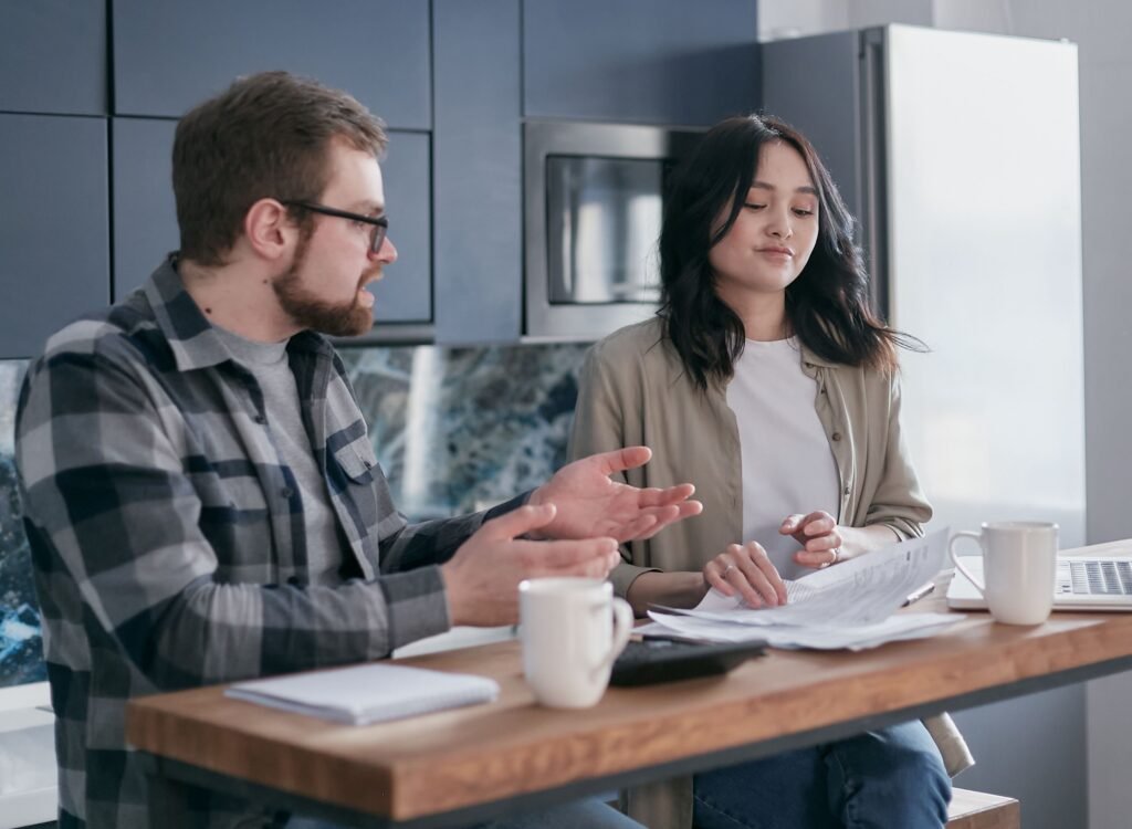 refinance mortgage decision with calculator, house keys and loan documents