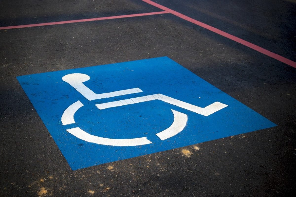Accessibility symbol on pavement, a reminder to ask do you need disability insurance