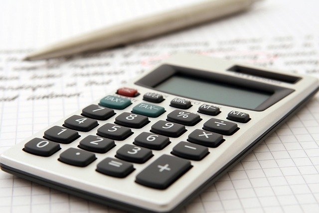 Accountant with a calculator, figuring estimated quarterly taxes