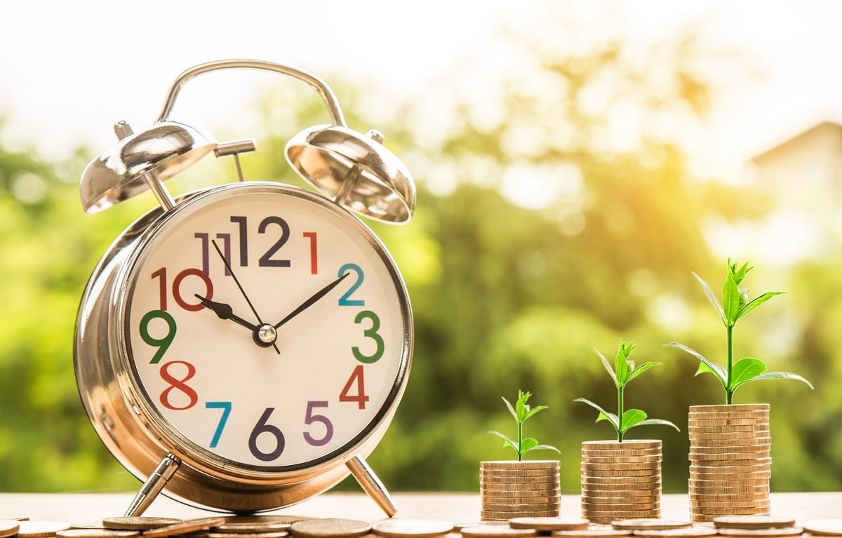 Alarm clock and growing coin stacks to stop lifestyle inflation