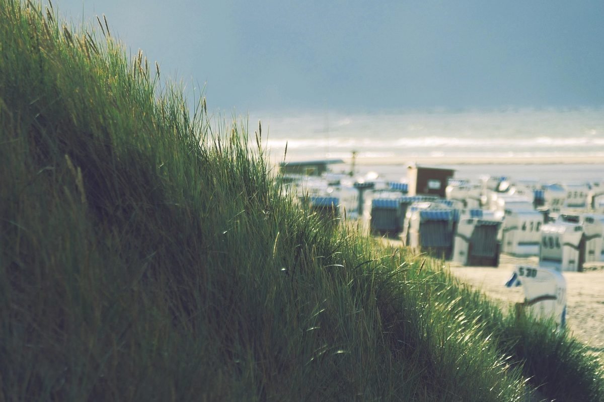 Beach chairs on dunes, a goal of investing for retirement