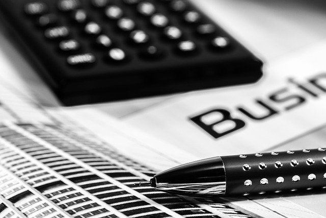 Calculator and pen on a desk, used to work out your utilization ratio