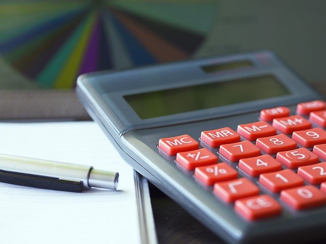 Calculator and pen for running a dollar-cost averaging vs lump sum simulation