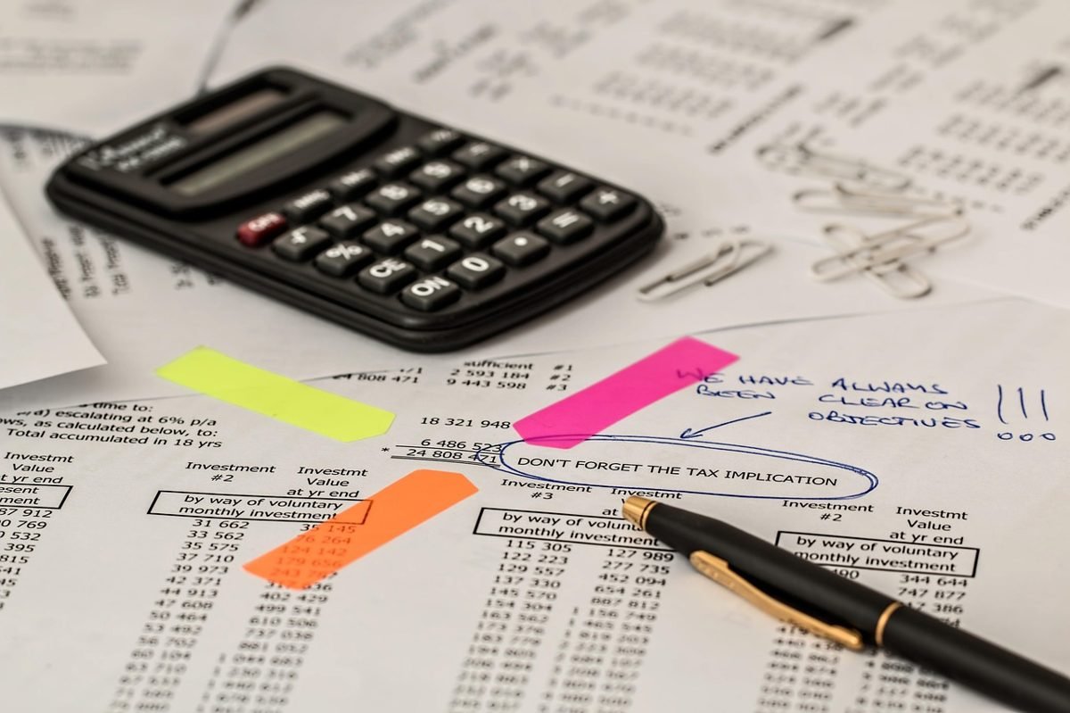 Calculator and tax papers for a solo 401k deduction