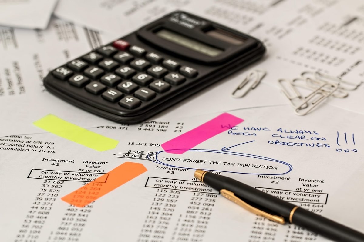 Calculator and tax papers beside a 1099 form