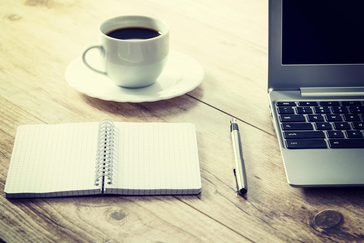 Notebook and coffee for planning your first $500 online