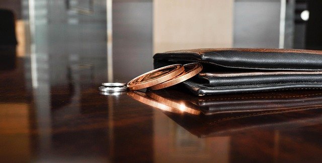 Coin and wallet on a table, answering what is a balance transfer