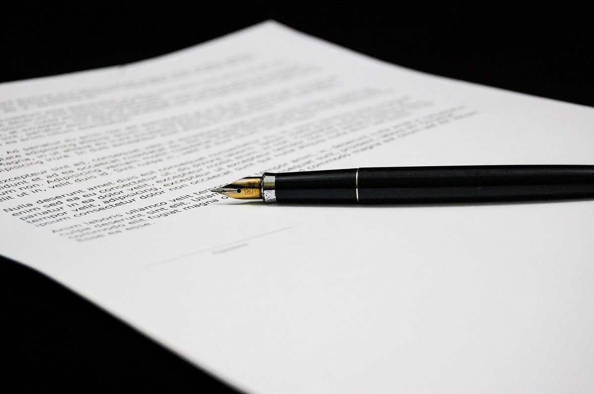 Policy document and pen after using a life insurance calculator