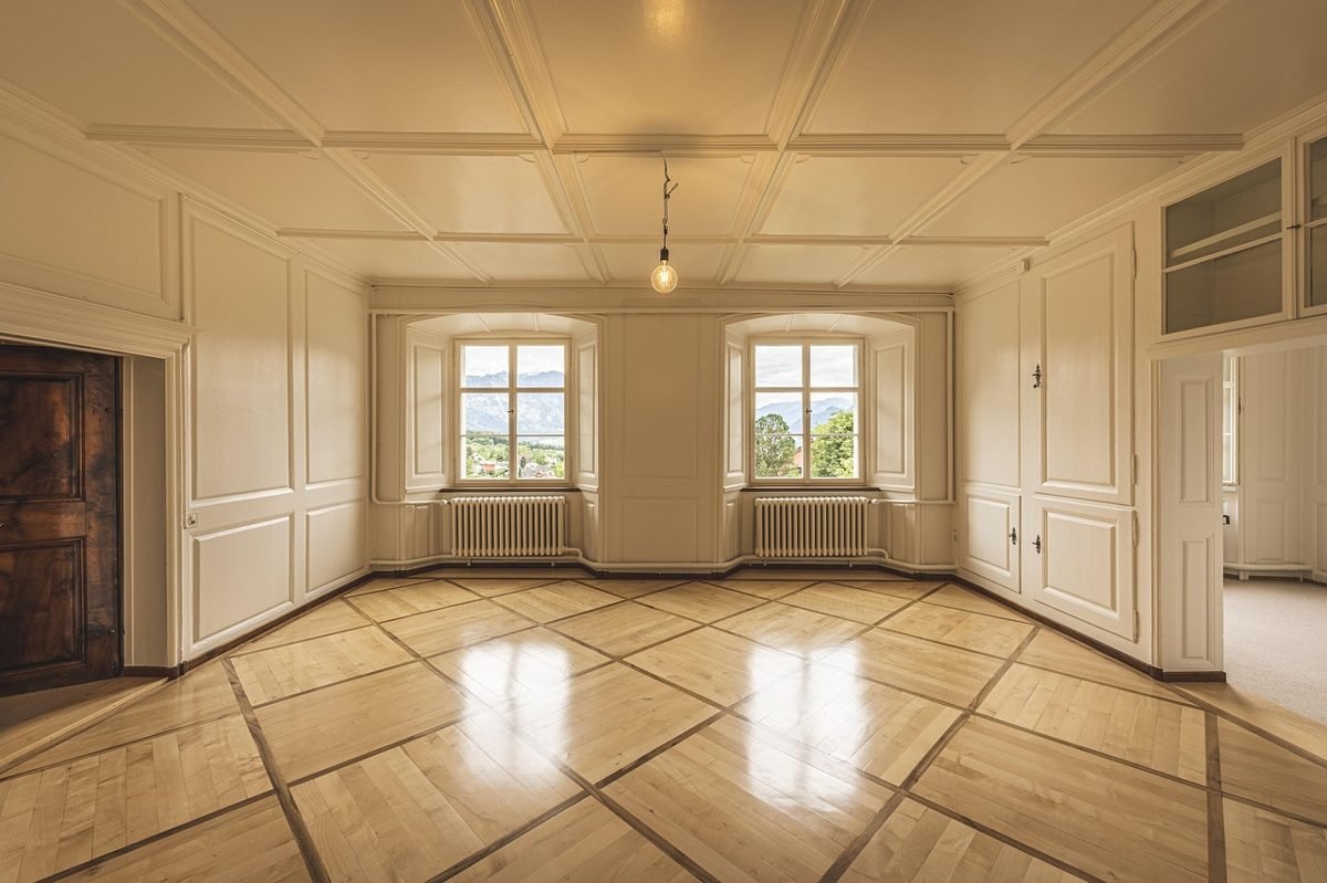 Empty apartment living room for a renter comparing monthly costs