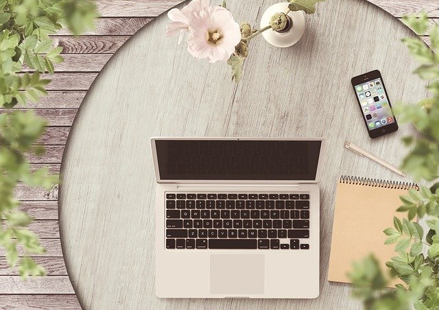 Laptop and phone on a desk, ready to open a Roth IRA online