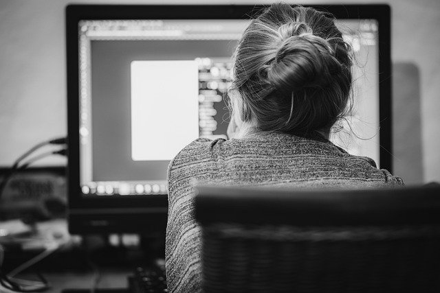 Freelancer working at a computer, a picture of freelance invoicing after the work is done