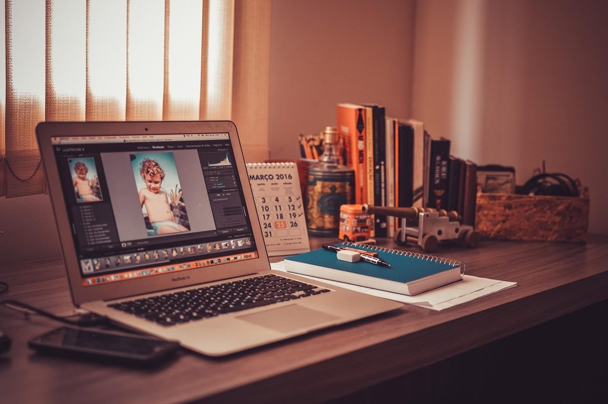 Freelancer home office desk with laptop where freelancer taxes are tracked