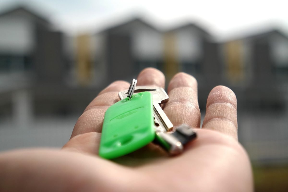 Hand holding a house key, the goal of a mortgage pre-approval