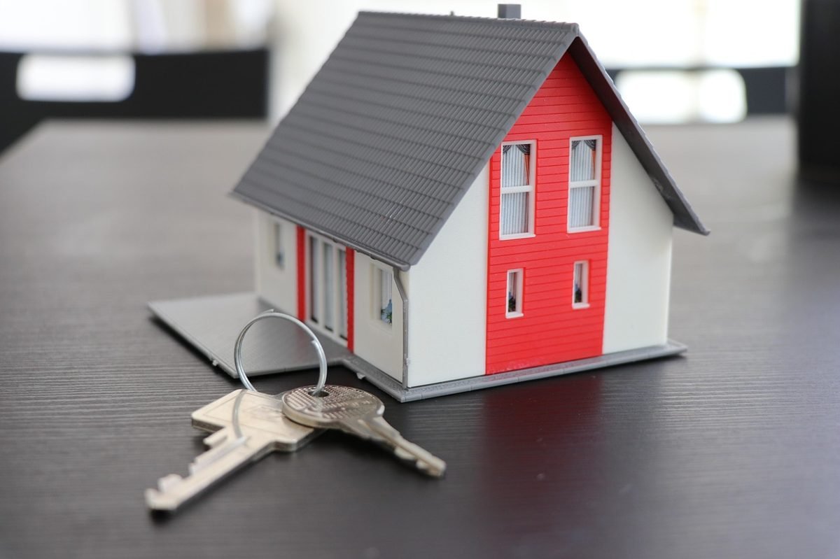 House model with keys representing the home closing process