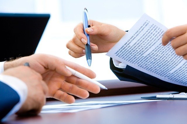 Laptop and notes on a desk, using what is a W-2 form to file taxes