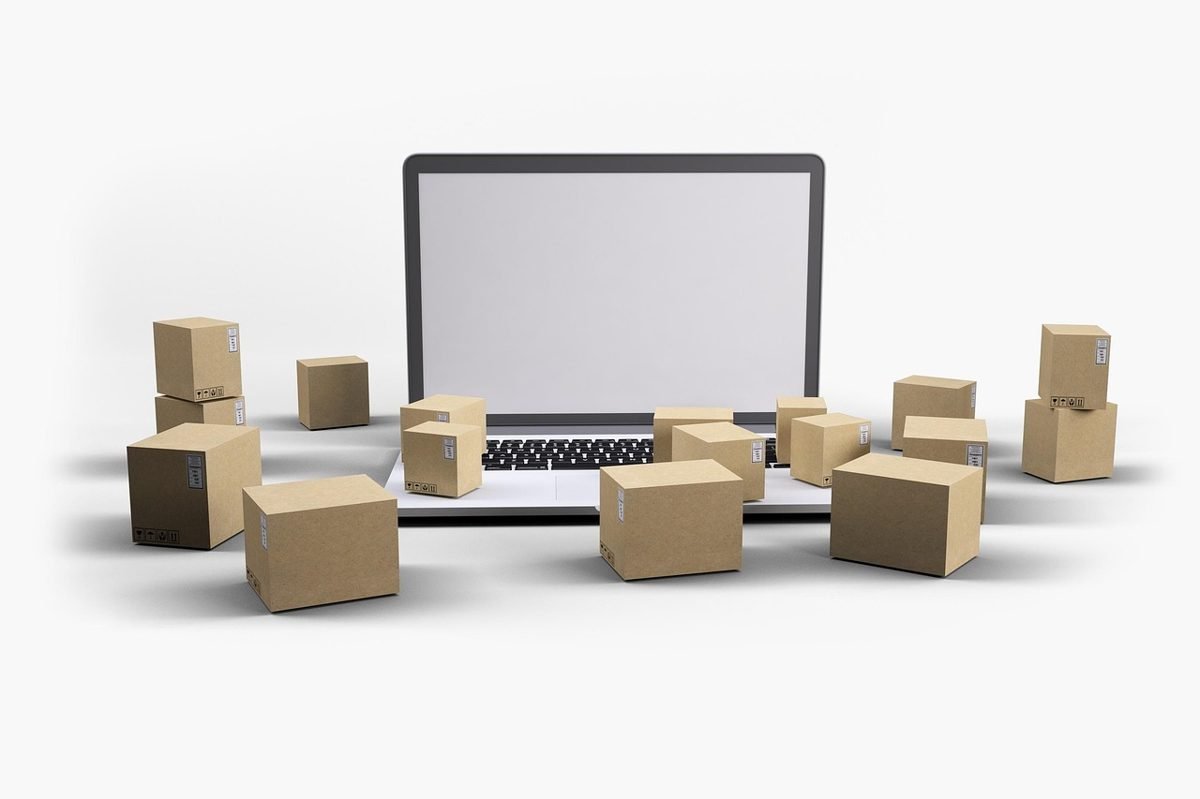 Laptop and boxes for selling items to reach your first $500 online