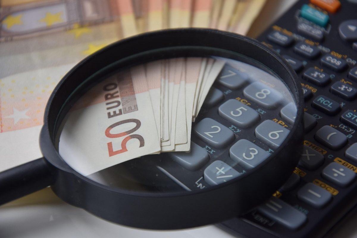 Calculator and money while checking how much to save for retirement