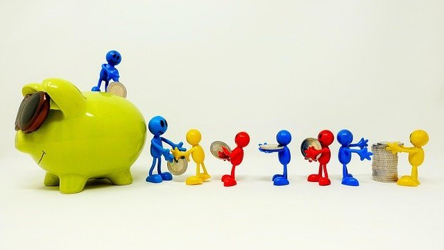 Piggy bank and coins, saving toward the 401(k) and IRA contribution limits 2026