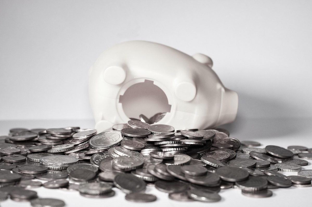 Piggy bank and coins representing a $500 starter savings buffer