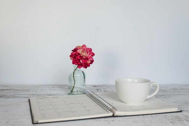 Planner open on a desk to track freelance invoicing due dates