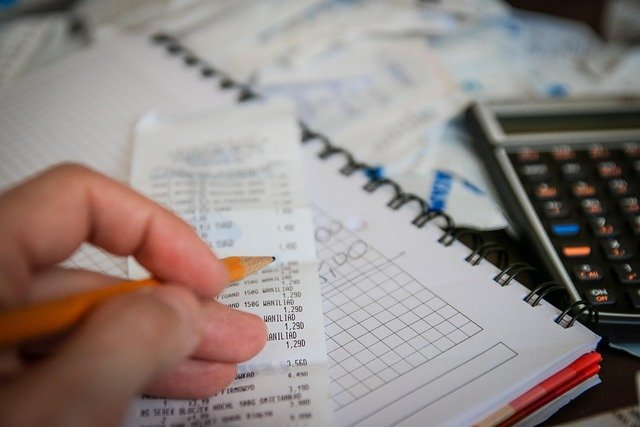 Receipts and calculator used to check W-4 withholding