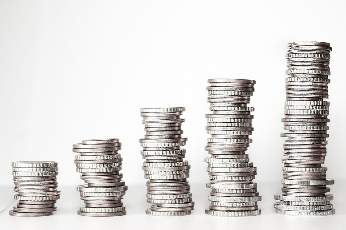 Rising stacks of coins illustrating compound interest at 25