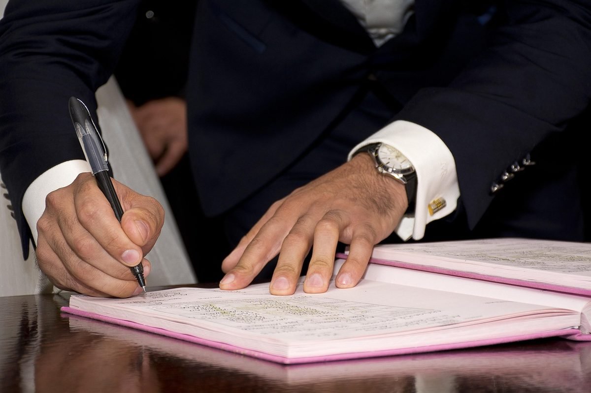 Buyer signing papers during the home closing process