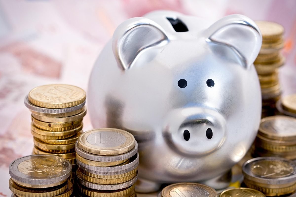 Piggy bank with coins, saving on self-employed health insurance