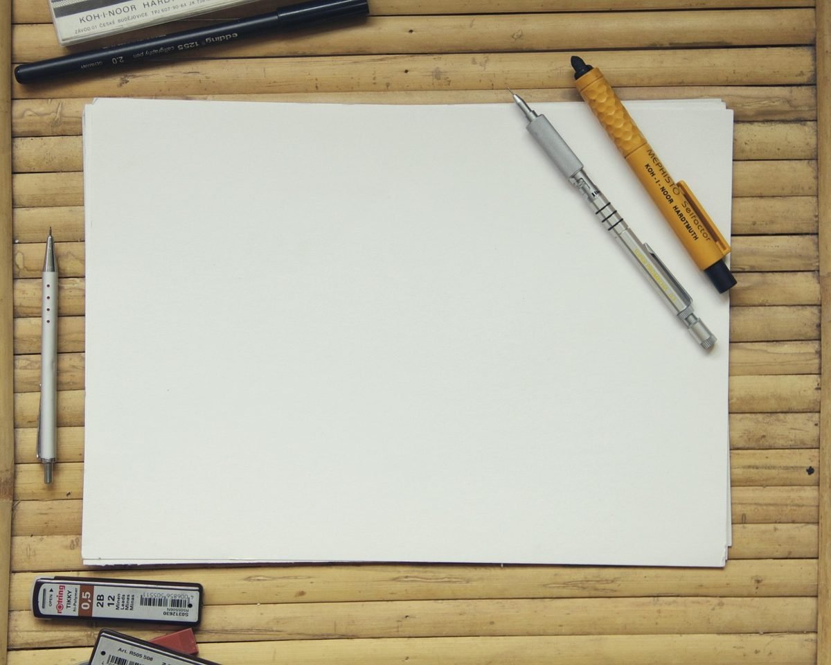 Blank sketch paper and pens for designing freelance service packages