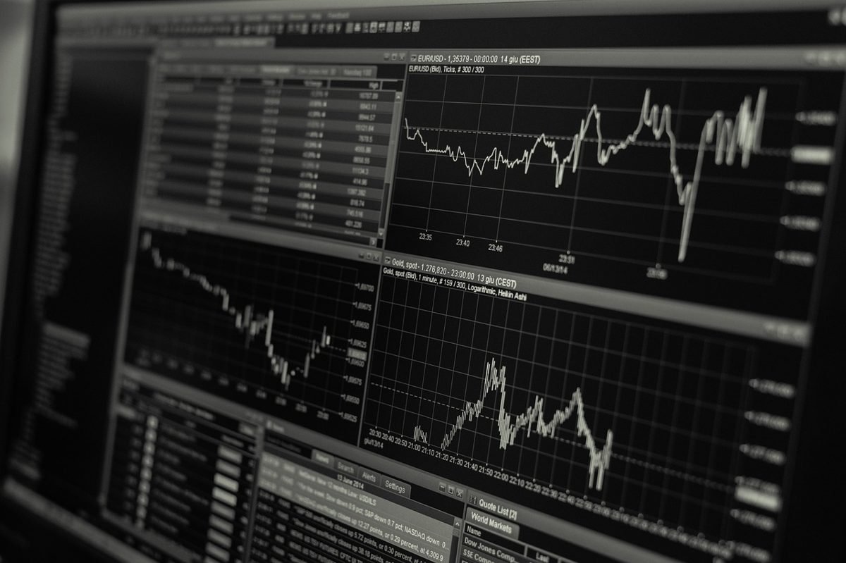 Stock market charts on a screen comparing index funds vs ETFs