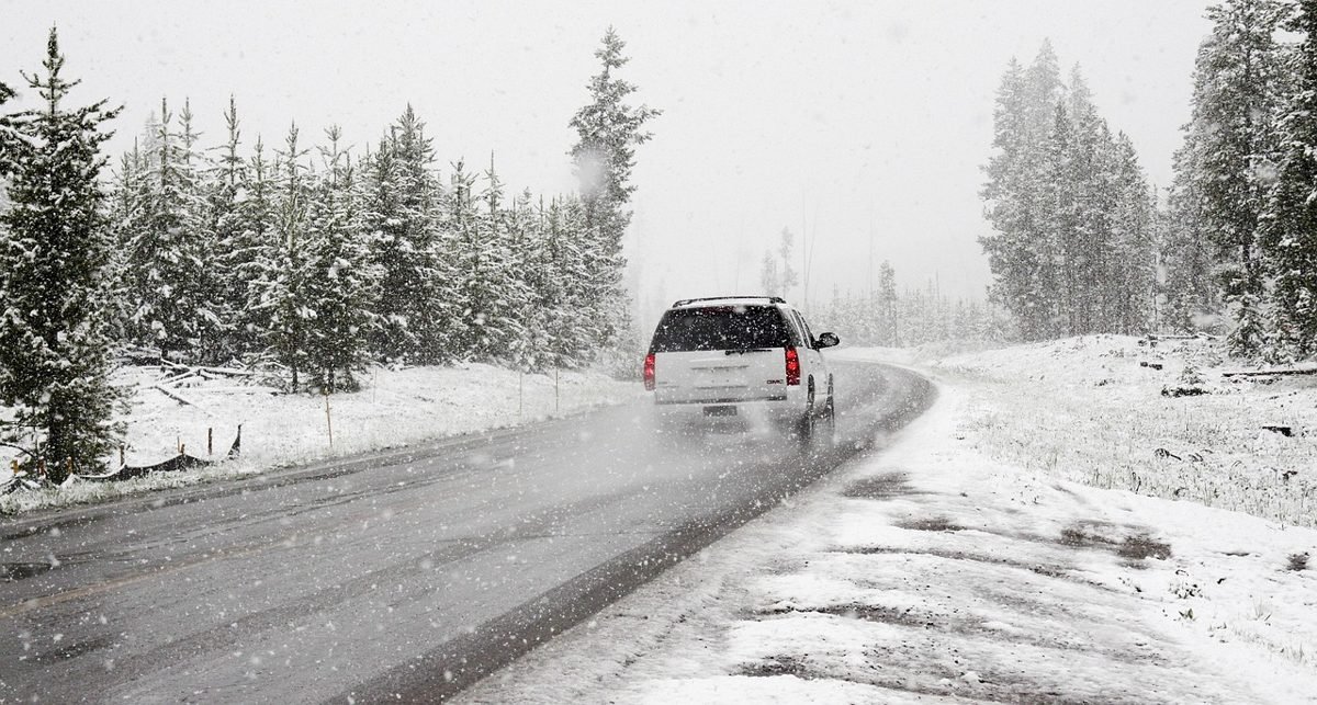 SUV on a snowy road, a risk to weigh when asking how much car insurance do you need
