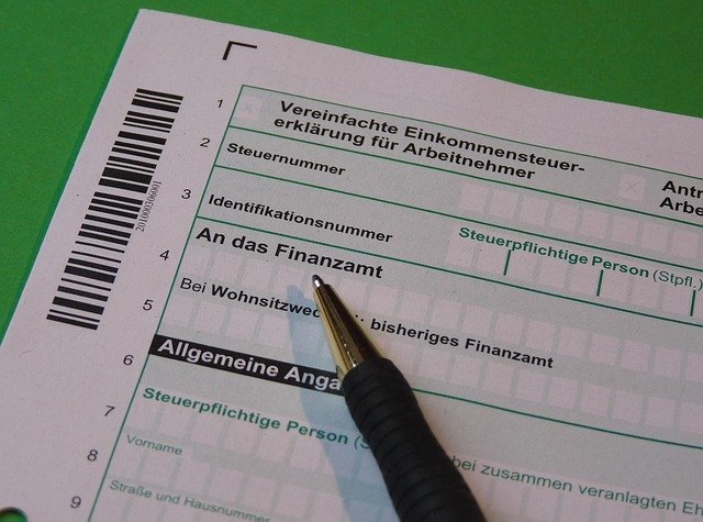 Tax papers and a calculator, tallying capital gains tax owed