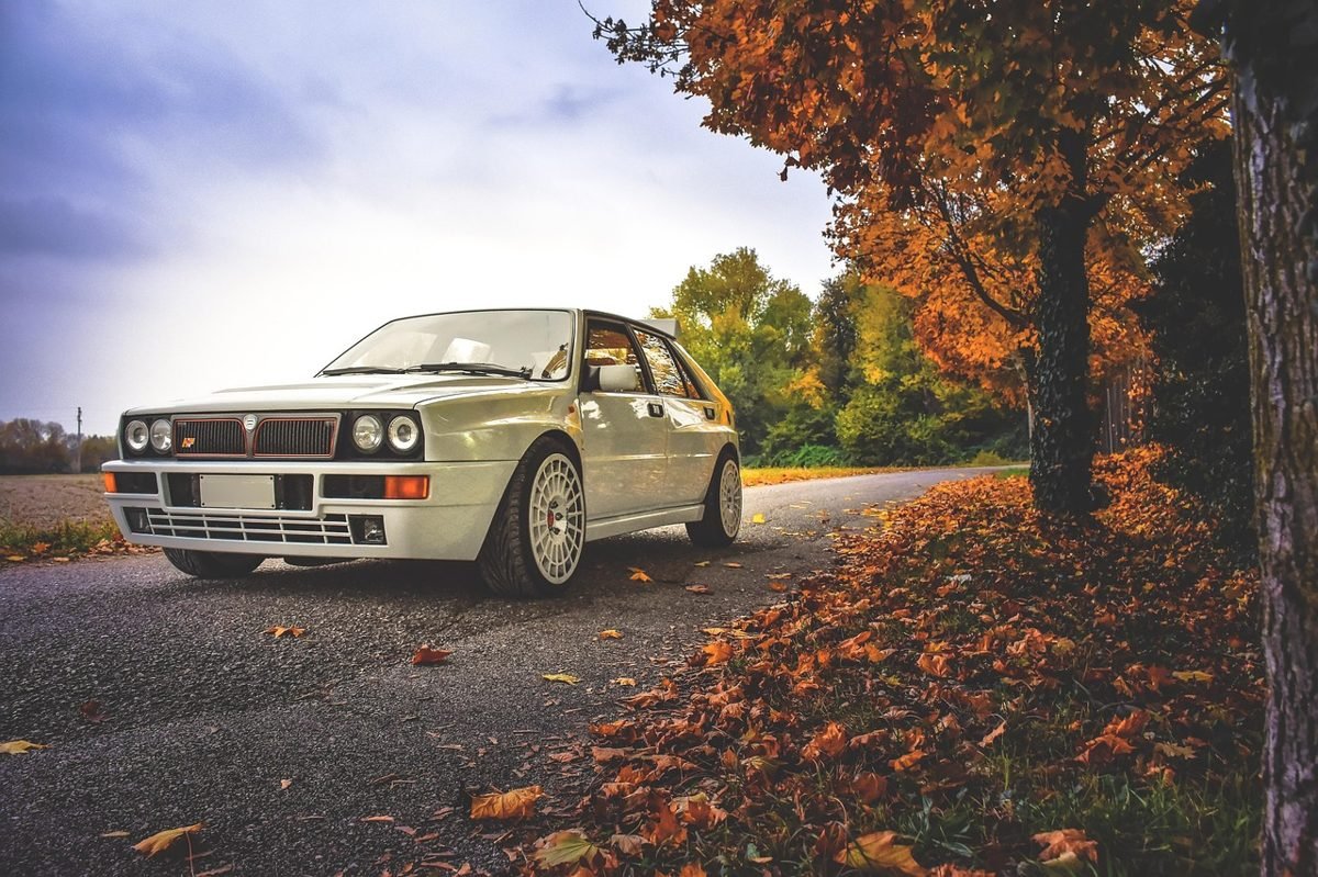 Car on an autumn road, where choosing the right car can lower car insurance rates