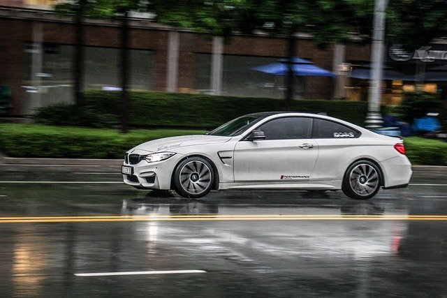 White coupe driving in the rain, a car you might lease vs buy a car